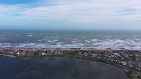 Residential-coastline-city-Frontignan-front-beach-aerial-drone-view.--Windy-day